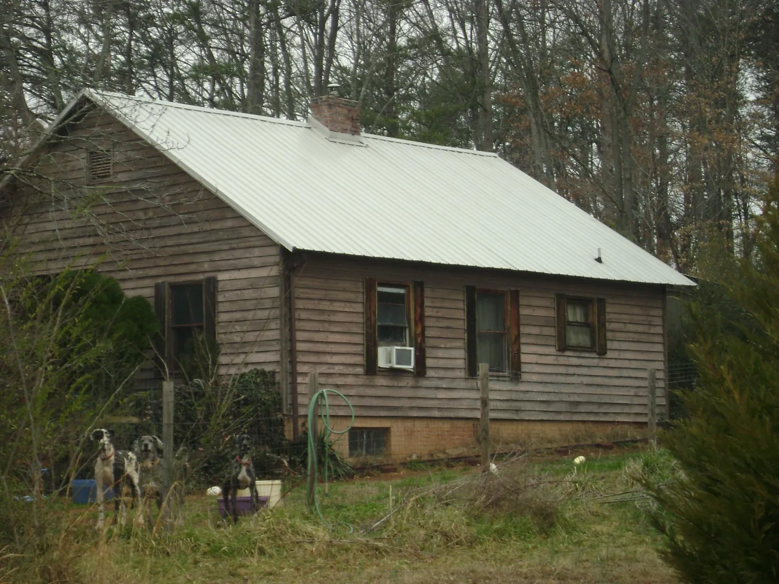 White metal roof on an old wood sided farmhouse, from a Metal Roof Installation job in Bouton